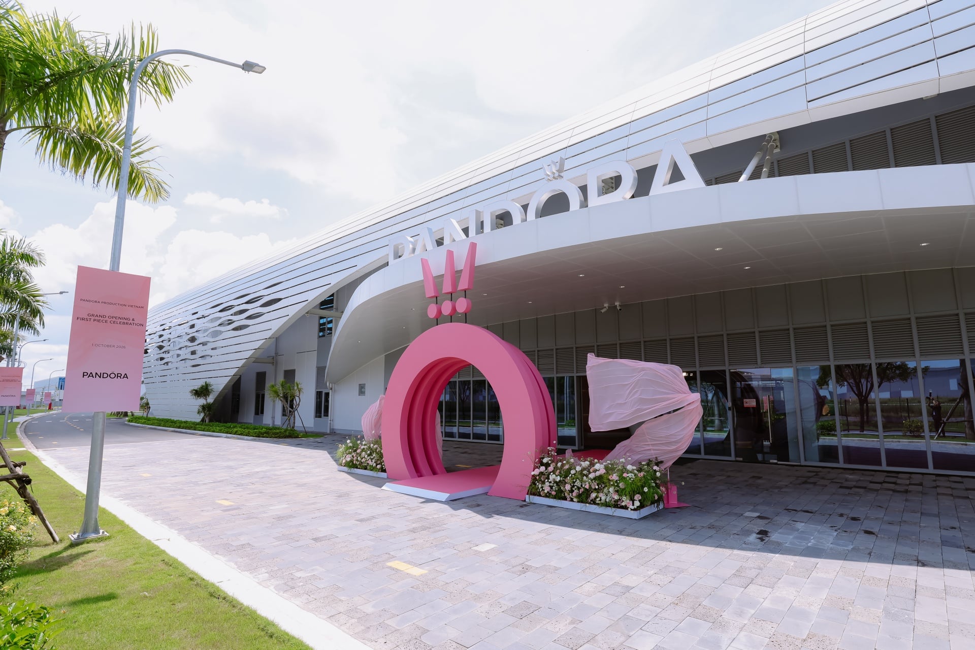 The new Pandora factory in Ho Chi Minh City: a white building with the Pandora lettering and a pink gate at the entrance
